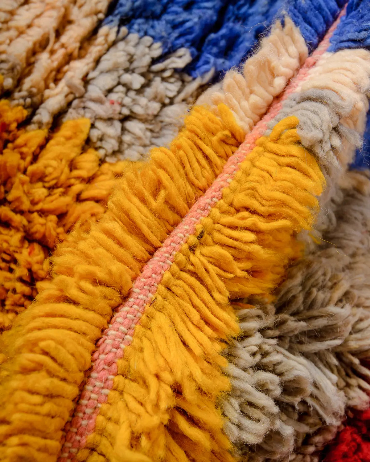Fluffy wool of a vintage rug up close.